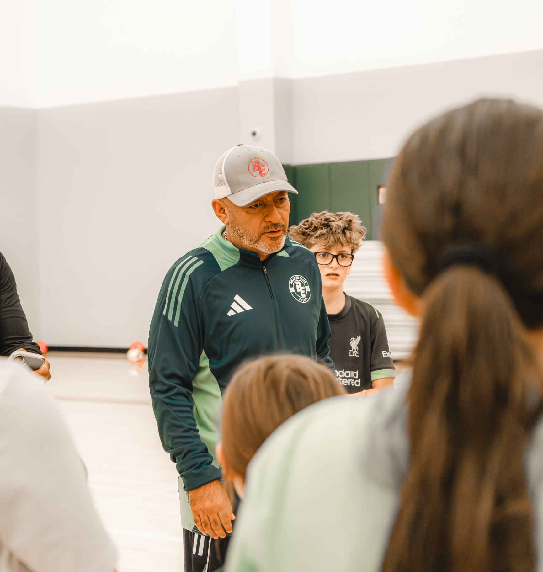 Coach Fabian Vega addressing players during the Founder's Clinic